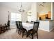 Dining area with large windows, chandelier, and seating for six, adjacent to the kitchen at 4776 Harrod Ct, Douglasville, GA 30135