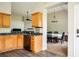 Charming kitchen featuring wood cabinets, dark countertops, and a view of the adjacent dining area at 4776 Harrod Ct, Douglasville, GA 30135