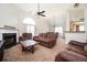 Inviting living room featuring a cozy fireplace, plush brown furniture, and a high ceiling at 4776 Harrod Ct, Douglasville, GA 30135