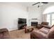 Bright living room with a decorative fireplace, high ceiling, and comfortable brown seating at 4776 Harrod Ct, Douglasville, GA 30135