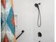 Nicely tiled shower featuring black fixtures and a patterned shower curtain at 4776 Harrod Ct, Douglasville, GA 30135