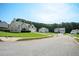 Serene street view features well-spaced homes and lush greenery under a clear blue sky at 4776 Harrod Ct, Douglasville, GA 30135