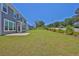 Expansive backyard with lush green lawn and views of the neighborhood at 611 Sugar Prairie Bnd, Lawrenceville, GA 30045