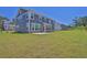 Large backyard featuring a spacious green lawn and a charming view of the home's exterior at 611 Sugar Prairie Bnd, Lawrenceville, GA 30045