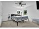 Bright bedroom features a ceiling fan, two windows offering natural light, and neutral paint at 611 Sugar Prairie Bnd, Lawrenceville, GA 30045