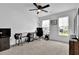Well lit room with office desk set up by two windows and a ceiling fan at 611 Sugar Prairie Bnd, Lawrenceville, GA 30045