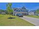 Two-story home with a manicured lawn and a paved driveway at 611 Sugar Prairie Bnd, Lawrenceville, GA 30045