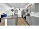 Modern kitchen featuring gray cabinets, stainless steel appliances, granite countertops and a kitchen island at 611 Sugar Prairie Bnd, Lawrenceville, GA 30045