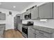 Modern kitchen features gray cabinets, granite countertops, and stainless steel appliances at 611 Sugar Prairie Bnd, Lawrenceville, GA 30045