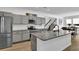 Modern kitchen features gray cabinets, granite countertops, stainless steel appliances, and a large center island at 611 Sugar Prairie Bnd, Lawrenceville, GA 30045