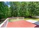 Lovely view of the wooded backyard from the home's wood deck with white railings at 1095 Northpoint Trce, Roswell, GA 30076