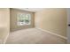 Bright bedroom with neutral carpet and a large window at 1095 Northpoint Trce, Roswell, GA 30076