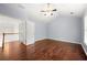 Spacious bedroom with hardwood floors, a ceiling fan, and access to additional rooms at 1095 Northpoint Trce, Roswell, GA 30076