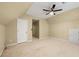 Upstairs bedroom features carpeting, a ceiling fan, and ample closet space at 1095 Northpoint Trce, Roswell, GA 30076