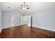 Spacious bedroom with hardwood flooring, a ceiling fan, and multiple access doorways at 1095 Northpoint Trce, Roswell, GA 30076