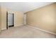 Bedroom with neutral walls and carpet, two doors, and minimal decor at 1095 Northpoint Trce, Roswell, GA 30076