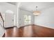 Bright entryway featuring hardwood floors, white walls, a stylish chandelier, and a view of the front door at 1095 Northpoint Trce, Roswell, GA 30076