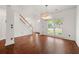 Bright entryway featuring hardwood floors, white walls, a stylish chandelier, and a view of the front door and staircase at 1095 Northpoint Trce, Roswell, GA 30076
