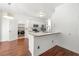 Bright kitchen with white cabinets, stainless steel appliances, and adjacent laundry room at 1095 Northpoint Trce, Roswell, GA 30076