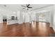 Open-concept living room with hardwood floors, view to the kitchen, and large windows providing ample natural light at 1095 Northpoint Trce, Roswell, GA 30076