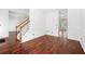 Spacious living room featuring hardwood floors and a staircase at 1095 Northpoint Trce, Roswell, GA 30076