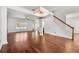 Open-concept living room with hardwood floors, staircase, natural light, and view into the kitchen at 1095 Northpoint Trce, Roswell, GA 30076