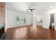 Spacious living room with hardwood floors, modern fireplace, and an open layout leading to the kitchen at 1095 Northpoint Trce, Roswell, GA 30076