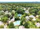 Aerial view of a neighborhood with tennis courts and a pool surrounded by mature trees and houses at 15 Vickwood Court Ne, Marietta, GA 30068