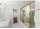 Well-lit bathroom with white tile flooring, vanity and framed glass door shower at 15 Vickwood Court Ne, Marietta, GA 30068