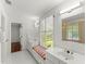 Bright white bathroom featuring double vanities, tiled floors, window seat and walk-in shower at 15 Vickwood Court Ne, Marietta, GA 30068