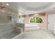 Updated bathroom featuring a glass shower, a garden tub, large windows, and natural light at 15 Vickwood Court Ne, Marietta, GA 30068