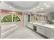 Serene bathroom featuring a soaking tub, double vanity, large windows and ample natural light at 15 Vickwood Court Ne, Marietta, GA 30068