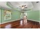 Inviting bedroom with tray ceilings, hardwood floors, draped windows and ample space for relaxation at 15 Vickwood Court Ne, Marietta, GA 30068