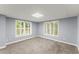 Spacious bedroom featuring two windows with white trim and neutral carpet at 15 Vickwood Court Ne, Marietta, GA 30068