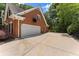 Attached two-car garage with an expansive driveway and basketball hoop at 15 Vickwood Court Ne, Marietta, GA 30068
