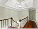 Upstairs hallway featuring hardwood floors and a decorative light fixture at 15 Vickwood Court Ne, Marietta, GA 30068