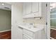 Wet bar area with hardwood floors, granite countertops and white cabinets at 15 Vickwood Court Ne, Marietta, GA 30068