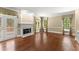 Bright living room featuring hardwood floors, a fireplace, and natural light through large windows at 15 Vickwood Court Ne, Marietta, GA 30068