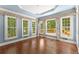 Bright sunroom with large windows, a vaulted ceiling, and access to the deck at 15 Vickwood Court Ne, Marietta, GA 30068