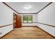 Bright bedroom with hardwood floors, natural light, and view into the hall plus a full wall to the backyard at 2775 Doaks Run Ct, Tucker, GA 30084