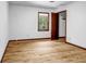 Bright bedroom features hardwood floors, window, and open closet at 2775 Doaks Run Ct, Tucker, GA 30084