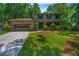 Charming two-story home featuring a brick facade, attached garage, and lush green lawn and landscaping at 2775 Doaks Run Ct, Tucker, GA 30084