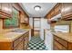 Charming kitchen with wood cabinets, checkered floors, and stainless steel sink at 2775 Doaks Run Ct, Tucker, GA 30084