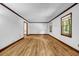 Bright living room features hardwood flooring, neutral walls, and natural light through well-placed windows at 2775 Doaks Run Ct, Tucker, GA 30084