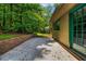 View of backyard patio, adjacent to the home, and with a brick retaining wall and lush green surroundings at 2775 Doaks Run Ct, Tucker, GA 30084