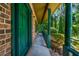 View of the covered porch area with painted brick columns and lush greenery in the background at 2775 Doaks Run Ct, Tucker, GA 30084