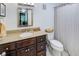 Bathroom featuring tile floors, dark wood vanity, granite countertop, and modern fixtures at 4604 Vinings Central Se Run # 131, Atlanta, GA 30339