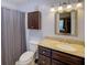 Bathroom with granite counters, dark cabinets, and shower-tub combo at 4604 Vinings Central Se Run # 131, Atlanta, GA 30339