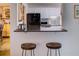 Breakfast bar featuring granite countertop and stylish stools, perfect for casual dining or entertaining guests at 4604 Vinings Central Se Run # 131, Atlanta, GA 30339