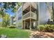 Apartment exterior featuring private balconies, lush landscaping, and beautiful green lawn at 4604 Vinings Central Se Run # 131, Atlanta, GA 30339